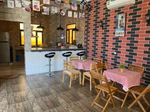 a restaurant with two tables and chairs and a counter at Alnoor Mirbat in Salalah