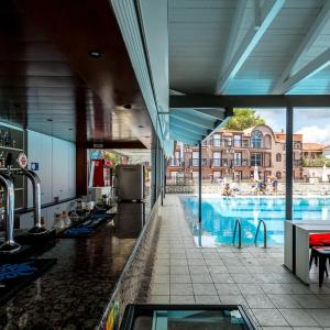 a large swimming pool with people in a building at Perkes Hotel Complex in Laganas