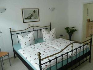 a bedroom with a large bed with white pillows at Ferienwohnung Familie Knak in Lassan