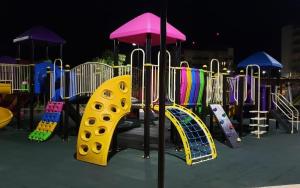 a playground with a yellow slide and a play structure at Praias do Lago Eco Resort in Caldas Novas