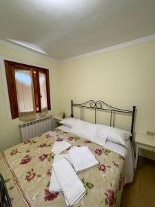 a bedroom with a bed with towels on it at Agriturismo Bicocchi in Piteglio