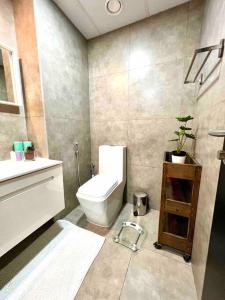 a bathroom with a toilet and a sink at Sunkissed holiday homes Modern 2BR Apt near JBR beach, Marina mall & DMCC metro in Dubai