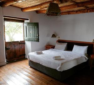a bedroom with a large bed and a window at Karoo 1 Hotel Village in De Doorns