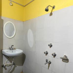 a bathroom with a sink and a mirror at King Thai Hotel and Restaurant in Kalimpong
