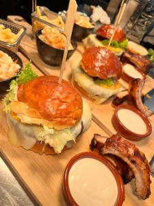 a group of sandwiches and bacon on a wooden tray at Black Forest Hotel Kappel-Grafenhausen in Kappel-Grafenhausen