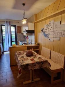 a kitchen with a table and chairs and a table and a kitchen at Casetta Loretta in San Pietro