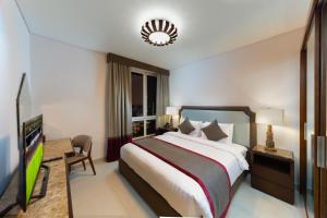 Ліжко або ліжка в номері Retaj Baywalk Residence