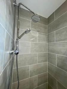 a shower with a shower head in a bathroom at Huntingdon Luxury Apartments in Huntingdon