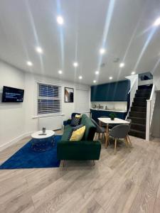 a living room with a couch and a table and stairs at Huntingdon Luxury Apartments in Huntingdon