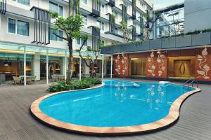 a large swimming pool in the middle of a building at Mercure Jakarta Sabang in Jakarta