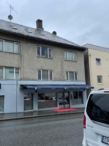 a white car parked in front of a building at Eiganesveien 1 in Stavanger