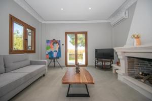 a living room with a couch and a fireplace at Adriana di Levante by "elite" in Ayios Kirikos