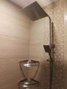 a shower with two baskets in a room at Adria Residences - Sapphire Garden - 2 Bedroom for 4 person in Manila