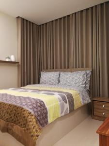 a bedroom with a large bed with curtains at Adria Residences - Sapphire Garden - 2 Bedroom for 4 person in Manila