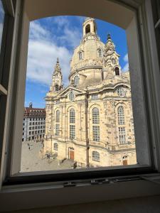 Blick auf ein großes Gebäude aus dem Fenster in der Unterkunft Aparthotel Altes Dresden in Dresden