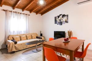 a living room with a couch and a table at Creta 2 bedrooms 6 persons village house in Vasilópoulon