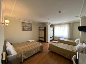 Postel nebo postele na pokoji v ubytování OTEL KING