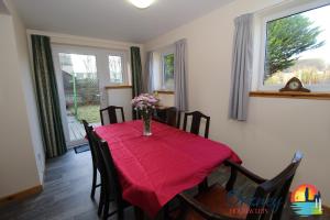 a dining room with a table with a vase of flowers on it at 89 Victoria Street, Kirkwall, Orkney - OR00066F in Orkney
