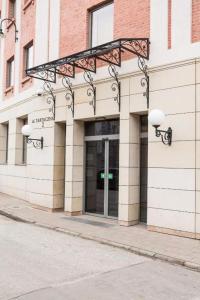 a building with a glass door with a sign on it at Apartament Old Town Gdańsk Tartaczna 16D in Gdańsk