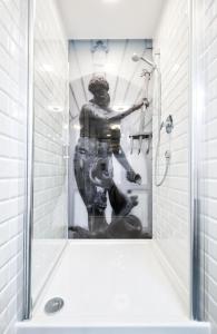 Una statua di un uomo in una doccia in bagno di Apartament Old Town Gdańsk Tartaczna 16D a Danzica
