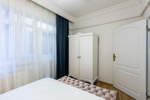 a bedroom with a bed and a cabinet and a window at Impres in Istanbul