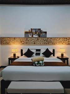 a bedroom with a large bed with two night stands at Penida Dream Homestay and hostel in Nusa Penida