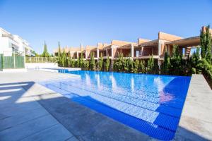 a swimming pool in a villa with blue water at 3082 Res LOMAS DE CAMPOAMOR in Orihuela Costa
