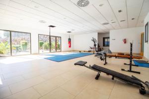 a fitness room with a gym with exercise equipment at 3082 Res LOMAS DE CAMPOAMOR in Orihuela Costa