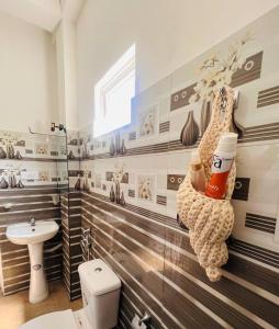 a bathroom with a monkey on the wall at Villa Sunimal in Unawatuna