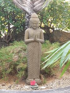 a statue of a woman praying in a garden at Brahmanhut - Eco Hut experience in harmony with nature, wellbeing and spirit in Bain Boeuf