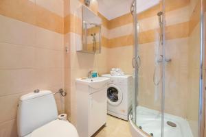 W łazience znajduje się toaleta, prysznic i pralka. w obiekcie Plac Wilsona Euphony Apartment w Warszawie