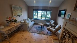 a living room with a couch and a fireplace at River View in Aldeburgh