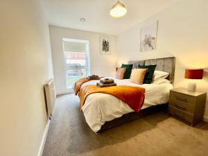 a bedroom with a bed with a teddy bear on it at Spacious 2 bed ground floor apartment, Free parking, close to Historic dockyard & Gunwharf Quays in Portsmouth