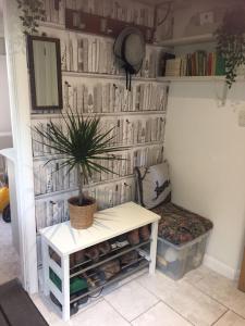 a room with a table and a plant on a wall at The Guest Suite, Buttsfield Lane. in East Hoathly