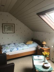 a bedroom with a bed in a attic at Haus Streitbürger in Bad Driburg