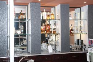 a bar with glass shelves with alcohol bottles at AG Palace Hotel in Addis Ababa