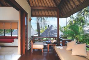 a living room with a couch and a table at Qunci Villas Resort in Senggigi
