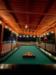 a pool table in the middle of a room with lights at Dreams Lodge Orosi in Cartago