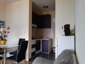 a kitchen with a white refrigerator and a table at Fei Fei Apartments 2 in Račišće