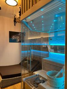 a shower with blue lights in a room at Hotel Winterrot in Karlsruhe