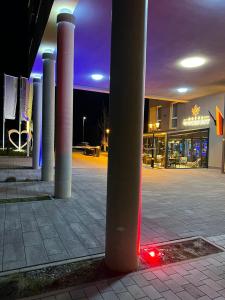 a group of columns in a parking lot at night at Hotel Winterrot in Karlsruhe