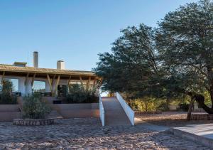 a house with a staircase leading up to it at Explora en Atacama - All Inclusive in San Pedro de Atacama