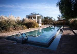 una piscina con cenador en un patio en Explora en Atacama - All Inclusive, en San Pedro de Atacama