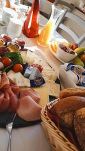 a table topped with lots of cheese and other foods at Pension Rio in Schneeberg