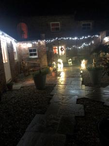 a house with lights on the side of it at night at Newsham Grange Farm in Thirsk