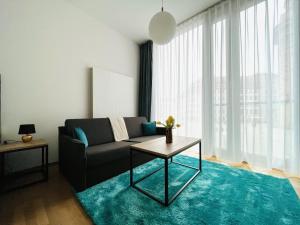 a living room with a couch and a table at Panoramastudio mit Blick zur Frauenkirche in Dresden