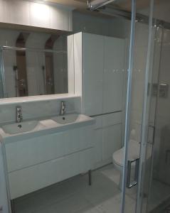 a bathroom with two sinks and a toilet at Kifissia center luxury in Athens
