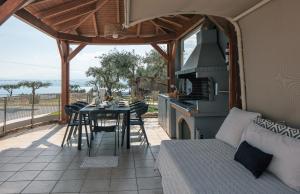 a patio with a table and a kitchen with a stove at Villa Panorama in Chania