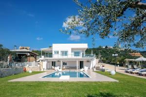 a villa with a swimming pool in front of a house at Villa Panorama in Chania