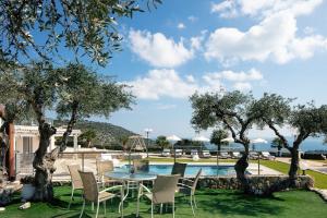 a patio with a table and chairs next to a pool at Villa Panorama in Chania Town